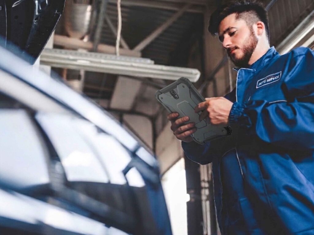 GO (18) Mechanic Inspecting a Car in Auto Repair Shop