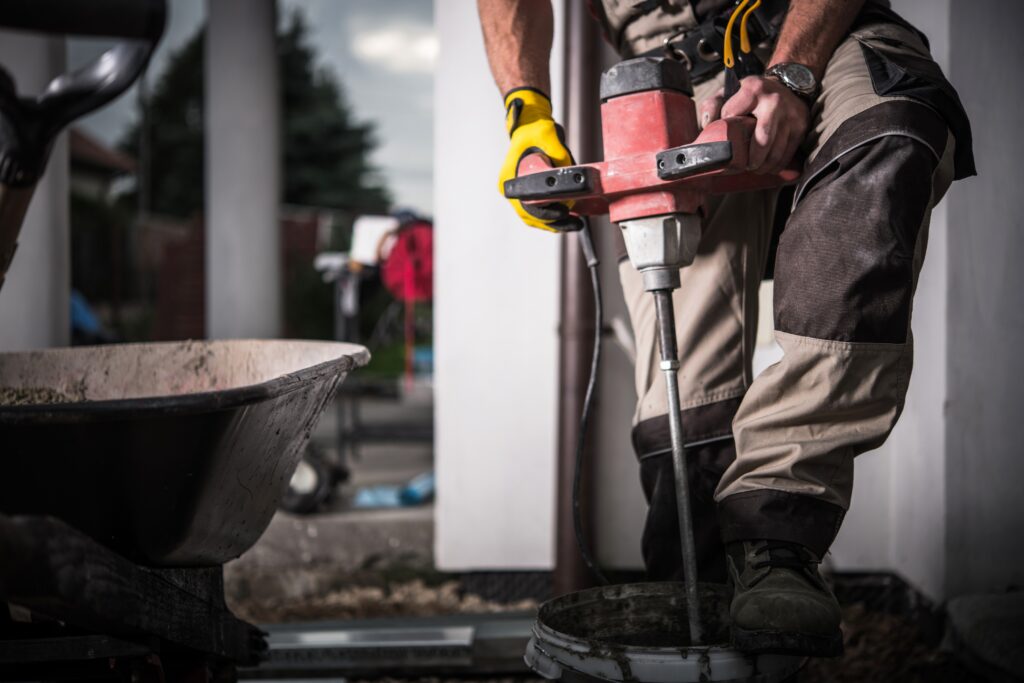 Construction Worker Mixing Cement with a Power Mixer