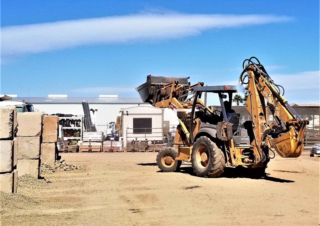 Yellow Backhoe on a Dirt Lot During Daytime Yellow Backhoe on a Dirt Lot During Daytime